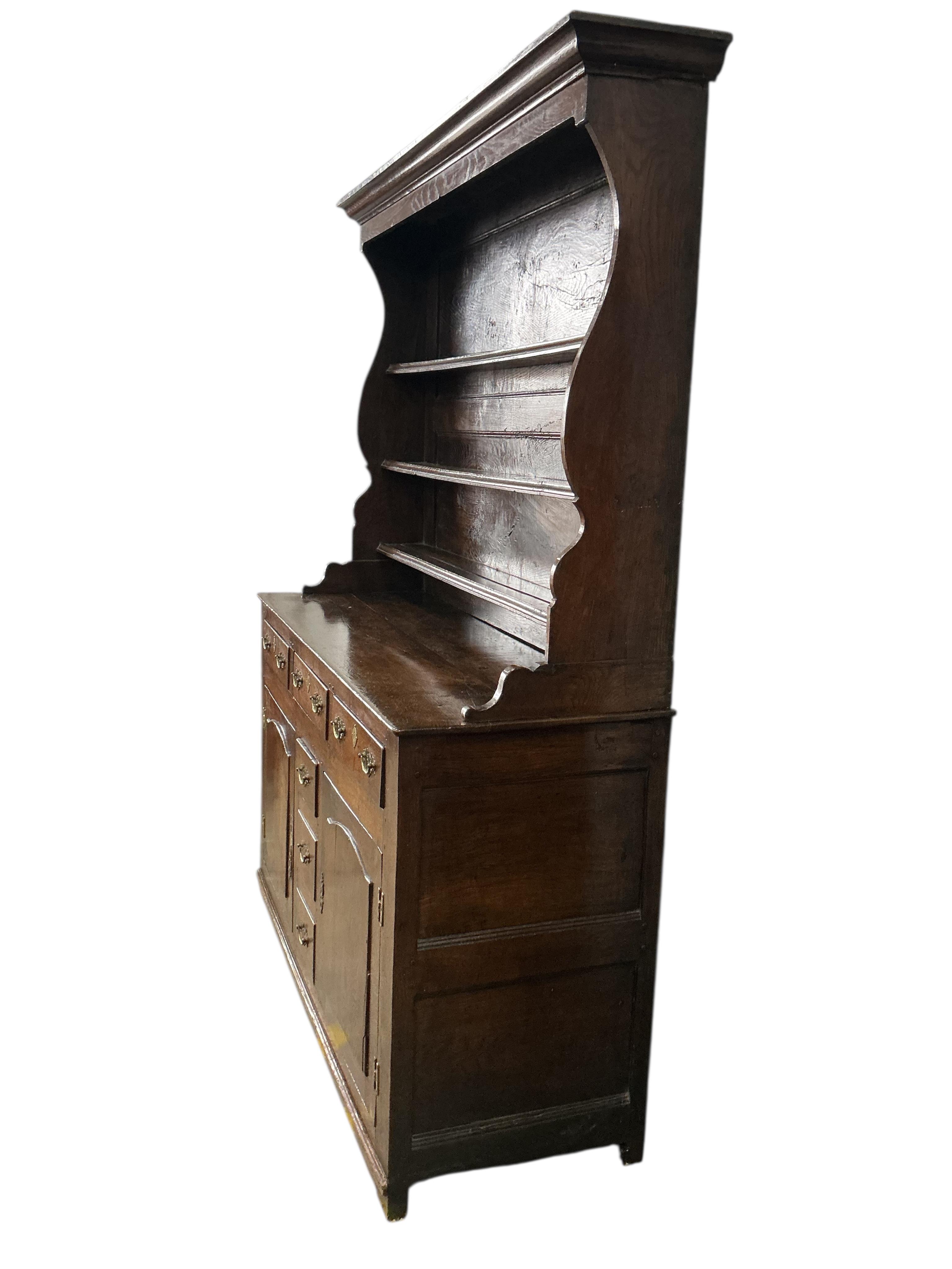 An early 18th century North Wales oak dresser, with boarded rack, width 144cm, depth 52cm, height 196cm